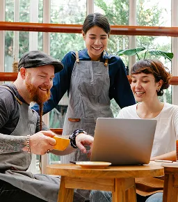 Group of people collaborating on a laptop